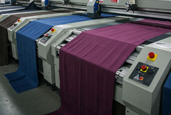Fabric moving through garment production equipment
